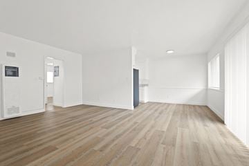 Redondo Beach apartment for rent - A room with wooden flooring and white walls.