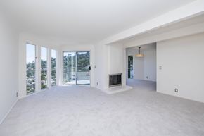 Sausalito apartment for rent - A spacious living room with a fireplace and sliding glass doors.
