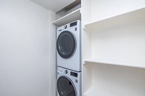 Sausalito apartment for rent - Two washing machines are stacked in a small space.
