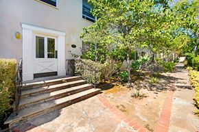 Santa Monica apartment for rent - A house with a white door and a small garden in front.