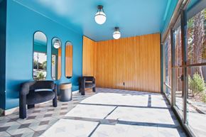 Los Angeles apartment for rent - A blue room with a black chair and a brown wall.