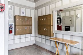 San Francisco apartment for rent - A white wall with a wooden table and a fire extinguisher on the left.