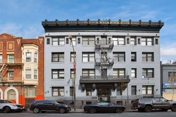 San Francisco apartment for rent - A grey building with a fire escape on the front.