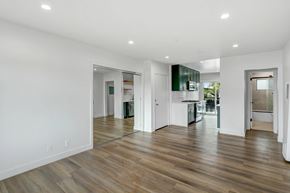 Los Angeles apartment for rent - A spacious room with wooden floors and white walls.