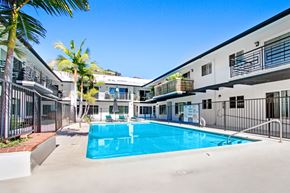 Los Angeles apartment for rent - A swimming pool in a sunny courtyard surrounded by buildings.