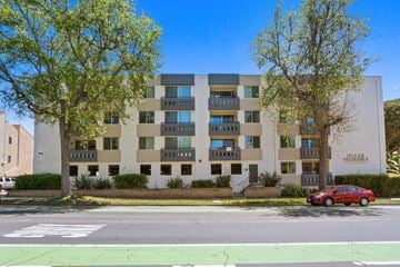 Santa Monica apartment for rent - A red car is parked in front of a building with a sign that reads "PATRIARCH".
