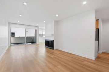 Santa Monica apartment for rent - A living room with a fireplace and a sliding glass door.