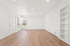 Santa Monica apartment for rent - A room with wooden floors and white walls.