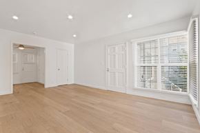 Santa Monica apartment for rent - A room with wooden floors and white walls.