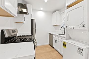 Santa Monica apartment for rent - A white kitchen with a black stove top and a white oven.