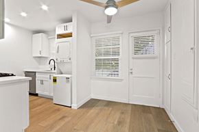 Santa Monica apartment for rent - A kitchen with white cabinets and a wooden floor.