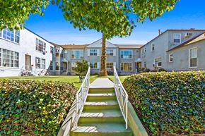 Santa Monica apartment for rent - A tree in front of a building with a staircase leading to it.
