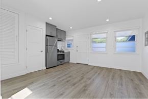 Santa Monica apartment for rent - A spacious kitchen with wooden flooring and white walls.