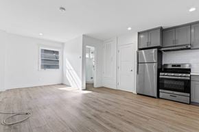 Santa Monica apartment for rent - A kitchen with a refrigerator, oven, and microwave.