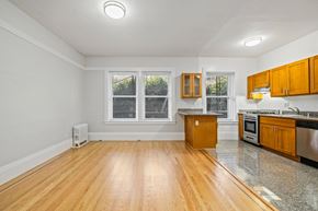 San Francisco apartment for rent - A kitchen with wooden floors and granite countertops.