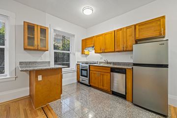 San Francisco apartment for rent - A kitchen with wooden cabinets and a granite countertop.
