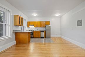 San Francisco apartment for rent - A kitchen with wooden cabinets and a granite countertop.