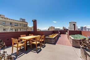 San Francisco apartment for rent - A wooden table and chairs are set up on a rooftop patio.