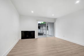 West Hollywood apartment for rent - A room with a fireplace and sliding glass doors leading to a balcony.
