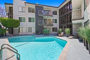 West Hollywood apartment for rent - A swimming pool in front of a modern apartment building.