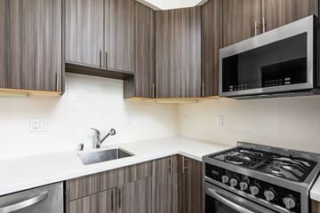 San Francisco apartment for rent - A modern kitchen with dark wood cabinets and stainless steel appliances.