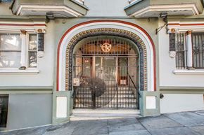 San Francisco apartment for rent - A building with a large arched doorway and a metal gate.