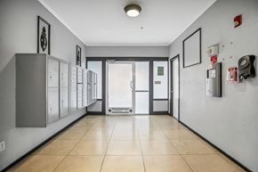 San Francisco apartment for rent - A hallway with a row of lockers on the left and a door at the end.