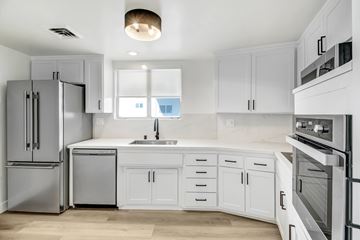 West Hollywood apartment for rent - A modern kitchen with white cabinets and stainless steel appliances.