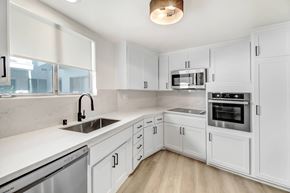 West Hollywood apartment for rent - A white kitchen with a stainless steel dishwasher and oven.