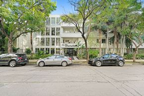 West Hollywood apartment for rent - Three cars are parked in front of a white building with the name Shearman on it.