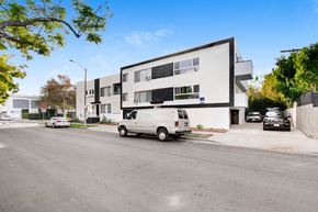 Los Angeles apartment for rent - a white van parked in front of a white building