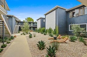Santa Monica apartment for rent - A modern courtyard with a concrete pathway and a variety of plants.