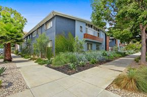 Santa Monica apartment for rent - A modern apartment building with a well-maintained garden in front.