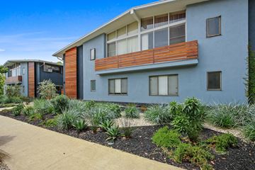 Santa Monica apartment for rent - A modern two-story building with a balcony and a garden in front.