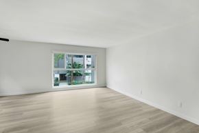 West Hollywood apartment for rent - A room with a window and wooden flooring.