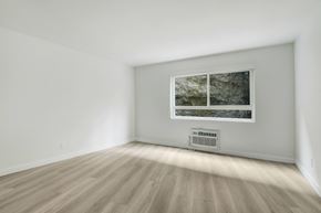 West Hollywood apartment for rent - A room with a window and a wall-mounted air conditioner.