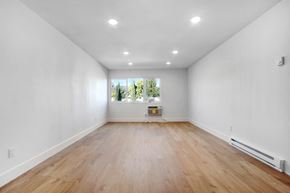 Los Angeles apartment for rent - A large empty room with wooden floors and white walls.
