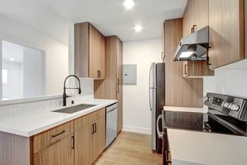 Los Angeles apartment for rent - A modern kitchen with wooden cabinets and stainless steel appliances.