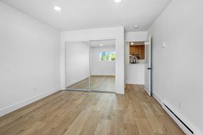 Los Angeles apartment for rent - A room with a white wall and a wooden floor.