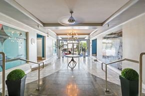 Santa Monica apartment for rent - A long hallway with a table and chairs in the middle.