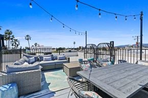 Santa Monica apartment for rent - A patio with a table, chairs, and a pool.