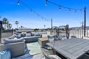 Santa Monica apartment for rent - A patio with a table, chairs, and a pool.