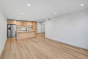 Santa Monica apartment for rent - A kitchen with a wooden counter and a refrigerator.