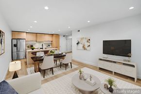 Santa Monica apartment for rent - A modern living room with a dining area and a kitchen in the background.