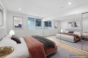 Santa Monica apartment for rent - A modern bedroom with a large bed and a glass walled room.