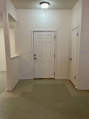 Pensacola house for rent - a room with a white door and a hallway with two doors