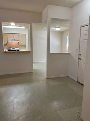 Pensacola house for rent - an empty living room and kitchen in an empty house