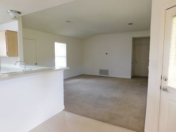 Pensacola house for rent - A white kitchen with a counter and a window.