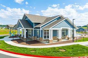 Harrisonburg apartment for rent - a blue house with a porch and a playground
