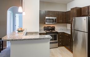 Charles Town apartment for rent - an empty kitchen with granite counter top and stainless steel appliances